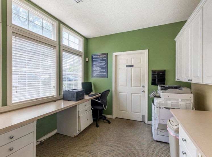Business Center with green accent wall, white cabinets, desks,  and computers